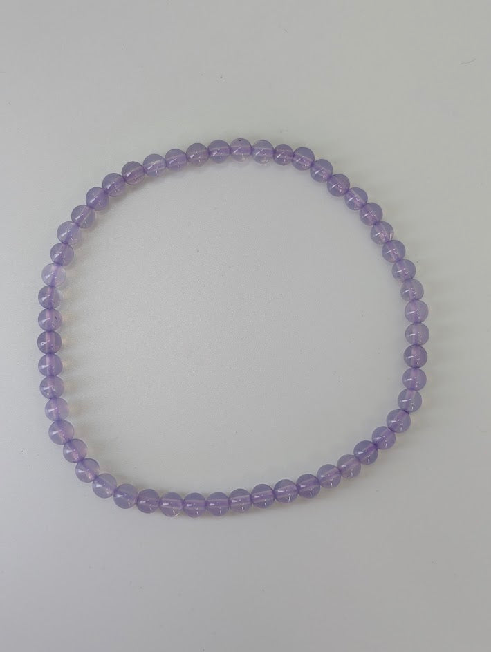4 mm Purple Jade bracelet laid flat on white background