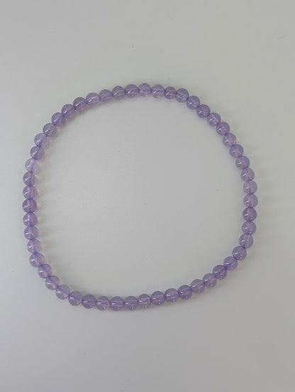 4 mm Purple Jade bracelet laid flat on white background