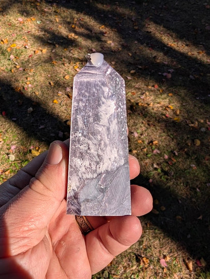 Close-up of polished Brazilian lepidolite showing sheeted texture and violet–silver sheen