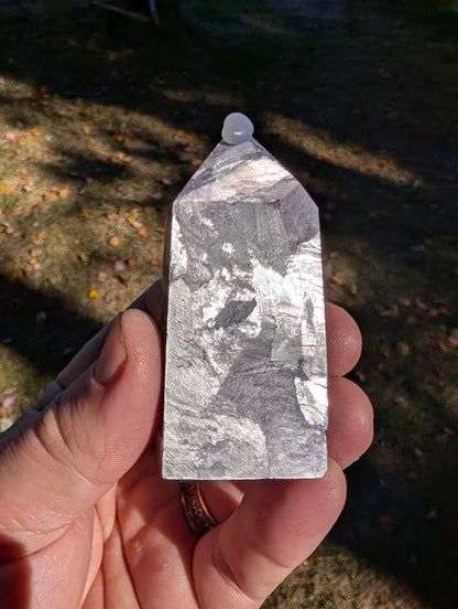 Close-up of polished Brazilian lepidolite showing violet–silver sheen and mica layering