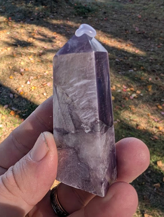 Angled shot of Purple Lepidolite tower highlighting layered mica reflections