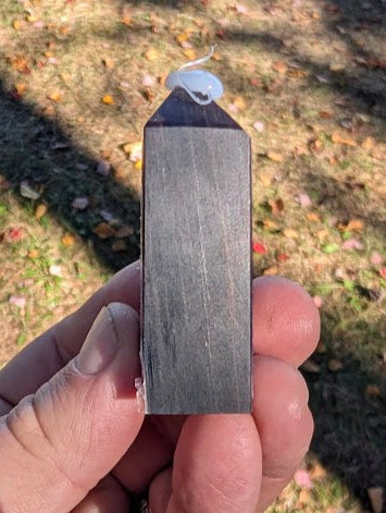 Angled view of polished Purple Lepidolite tower with violet and silver reflections