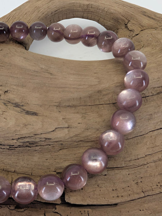 Close-up of 7mm Purple Mica beads highlighting the silky chatoyancy and natural lithium-mica shimmer.