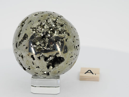 Peruvian Pyrite sphere Specimen A (405g) displaying large natural crystal vug and mirror polish.