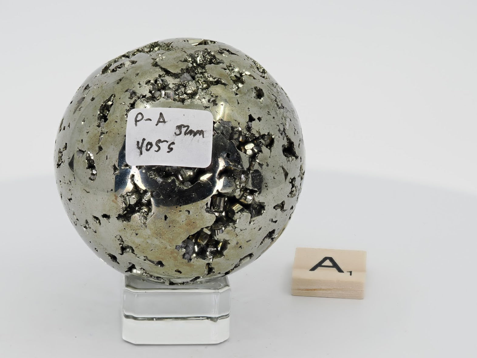 Peruvian Pyrite sphere Specimen A with label showing 405g weight and 52mm diameter.