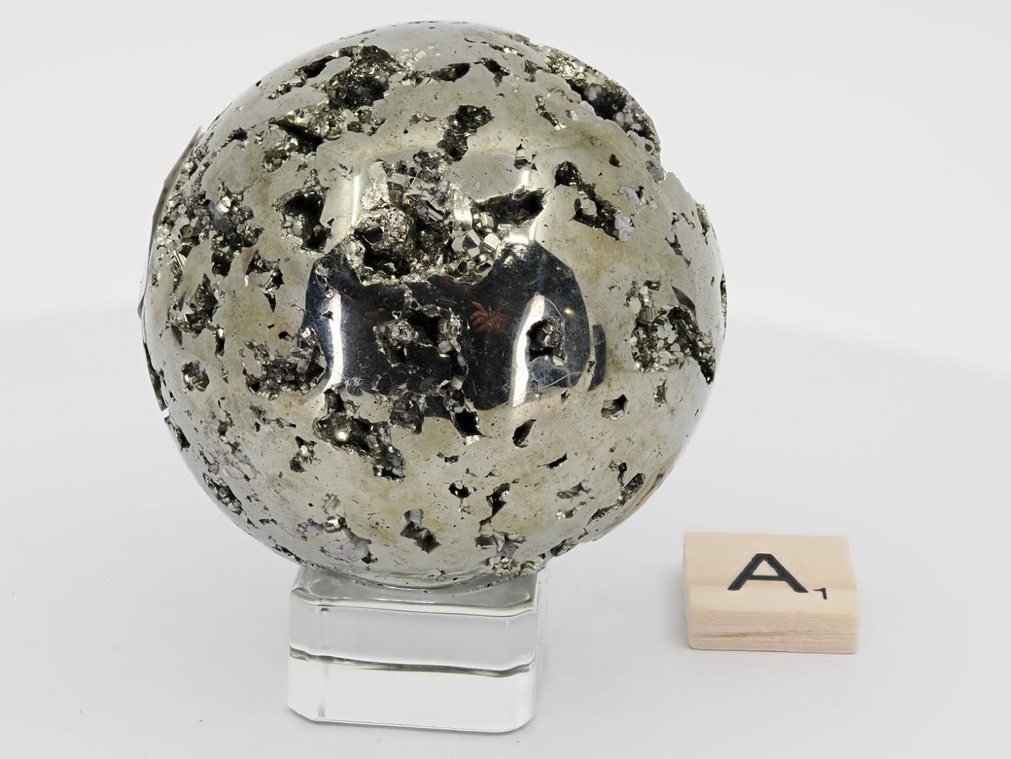 Angled view of 405g Pyrite sphere A showing spherical form and complex texture.