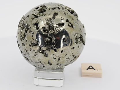 Angled view of 405g Pyrite sphere A showing spherical form and complex texture.