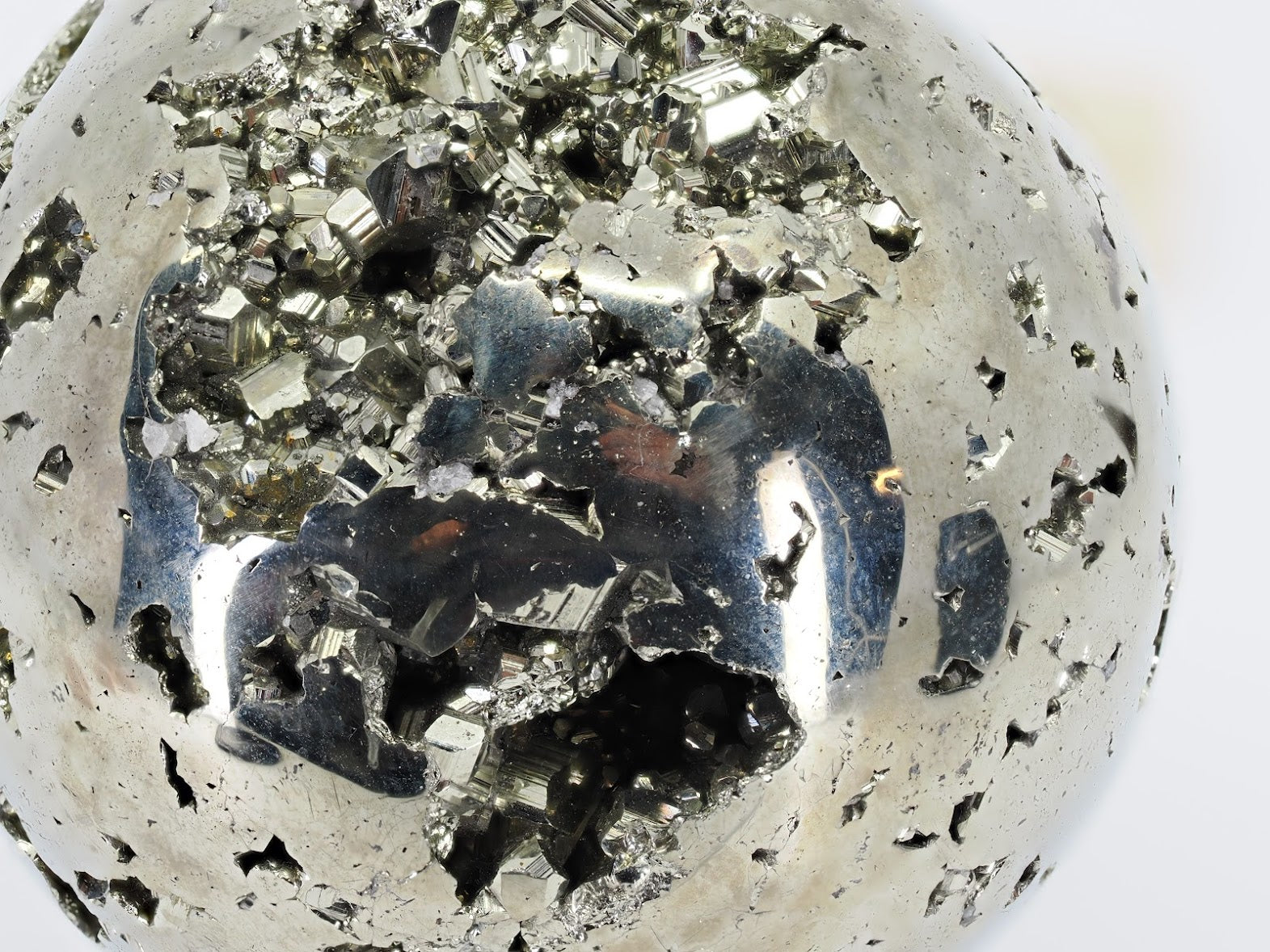 Macro detail of sharp cubic pyrite crystals inside the natural cavity of sphere A.
