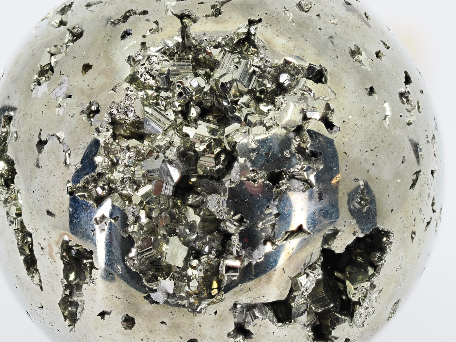 Deep look into the crystal-lined cave of Pyrite sphere A showing metallic luster.