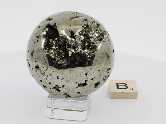 Detail of natural pyrite crystal cave and open vug on polished sphere B.