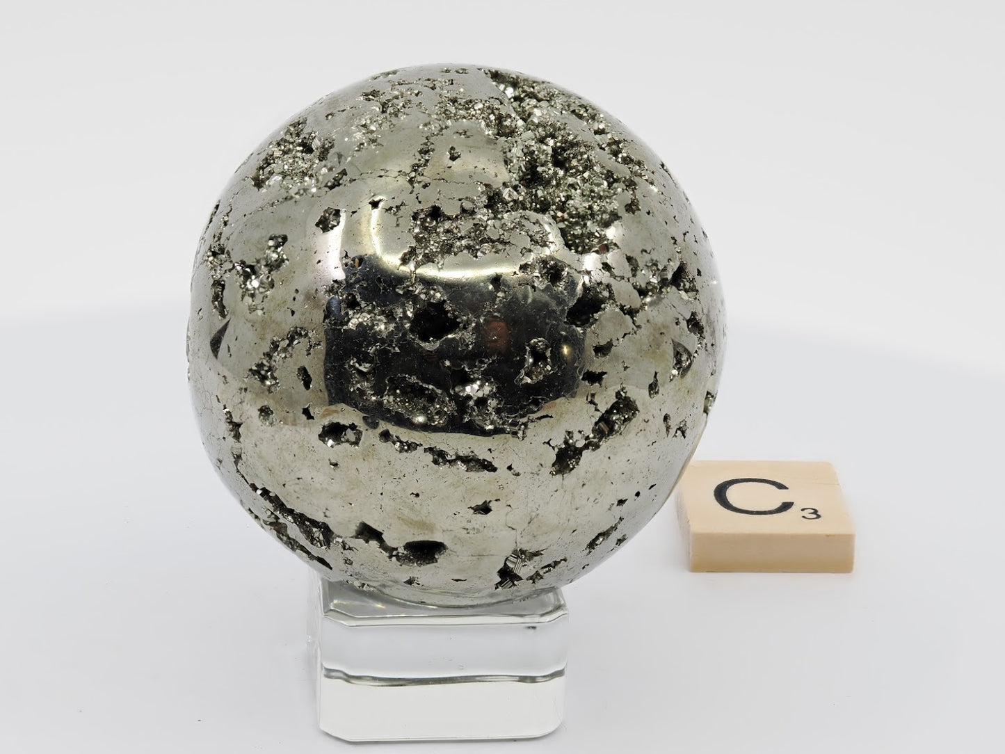 Close up of metallic texture and deep crystal vugs on Pyrite sphere C.