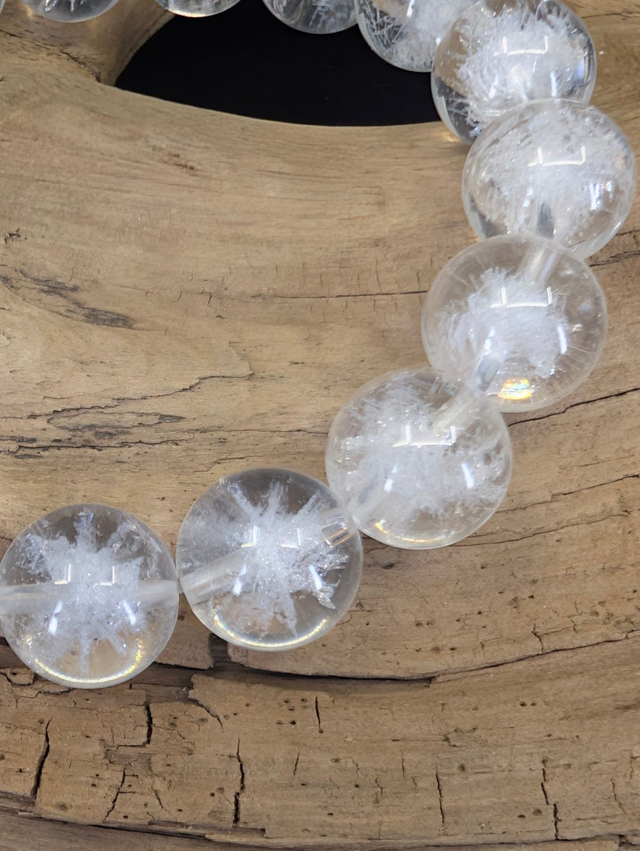 Close-up of 12mm Quartz beads showing the intricate white man-made urchin inclusions and high transparency.