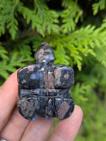 Top view of a Que Sera Llanite turtle carving, highlighting the blocky, geometric lines carved into the shell and distinct blue quartz spots.