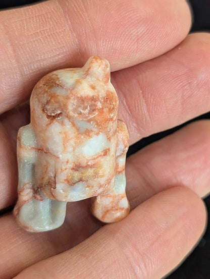 Front view of a 3cm R2-D2 carved from natural, mottled pink and white Jasper.