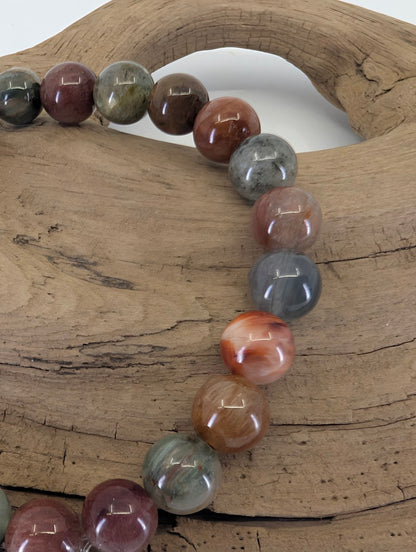 6.5mm Rabbit Hair Rutile Quartz bracelet in 'Earthy Multi' showing red, orange, and smoky-grey rutile inclusions.