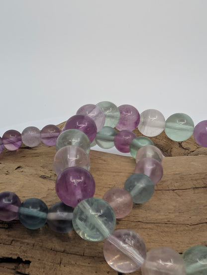 Closeup of rainbow fluorite beads highlighting translucent color zoning