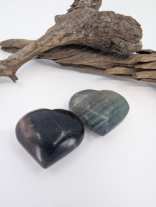 Pair of Rainbow Fluorite hearts showing deep purple and green banding variations.