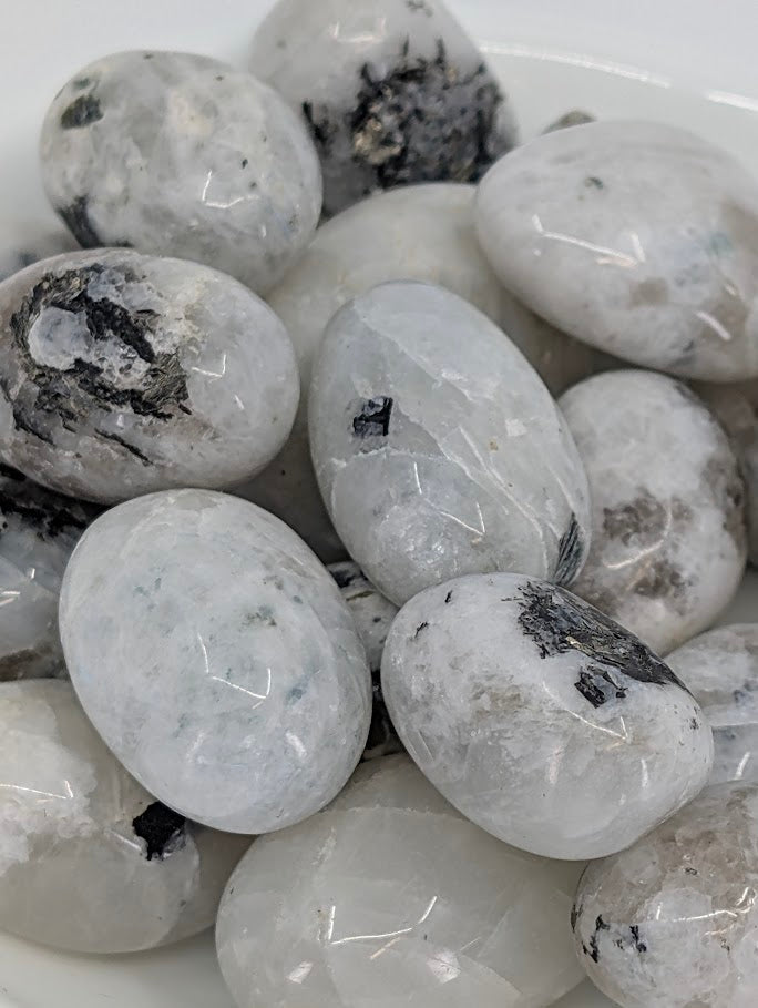 Close-up showing adularescence and tourmaline inclusions