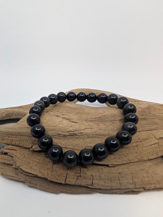 8mm rainbow obsidian bracelet with mirror-black beads on driftwood