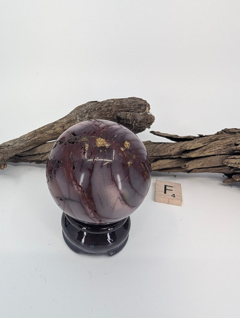 Close up of the natural pitting and crazing on an Earth Grade Mookaite sphere.