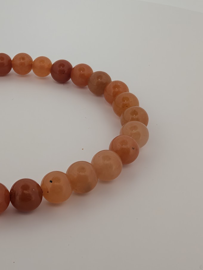 6mm red aventurine bracelet showing polished finish and color variation
