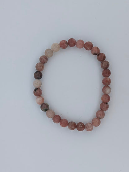 Top-down view of 6mm red aventurine with septarian bracelet on white background