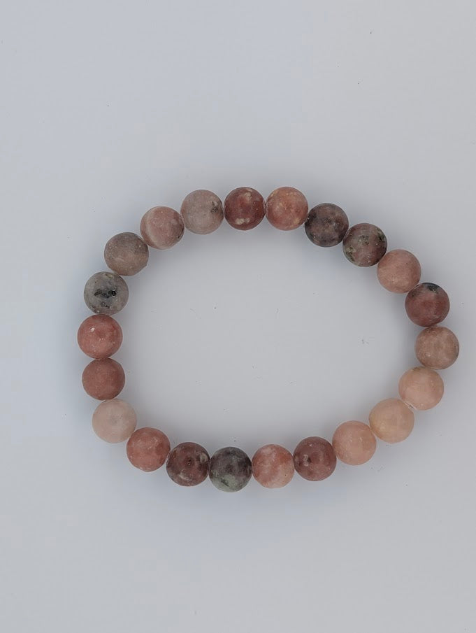 Top-down view of 8mm red aventurine with septarian bracelet on white background