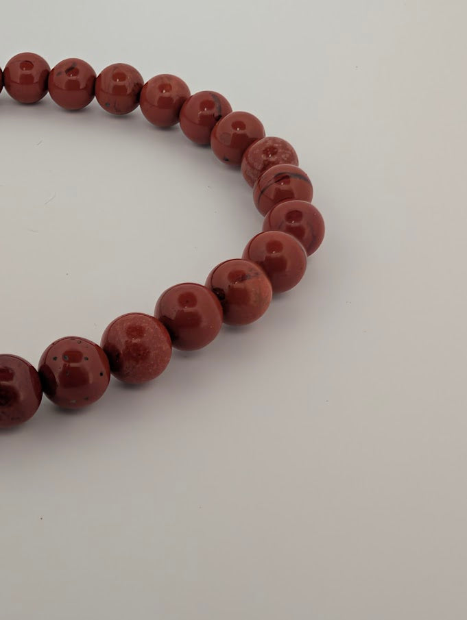 Detail of 6mm red jasper beads in stretch bracelet