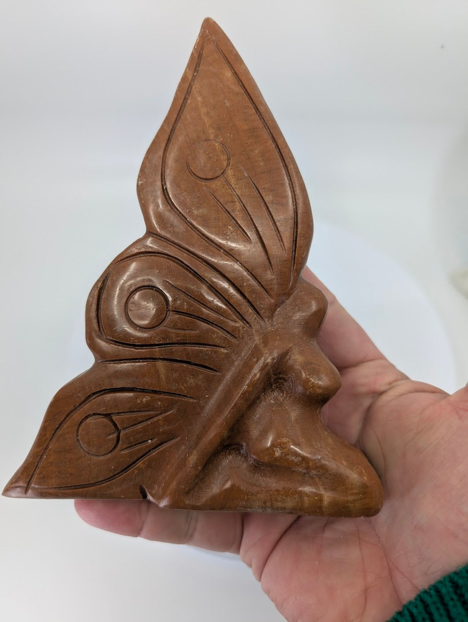 Red Jasper Fairy Goddess carving with polished wings in hand for scale