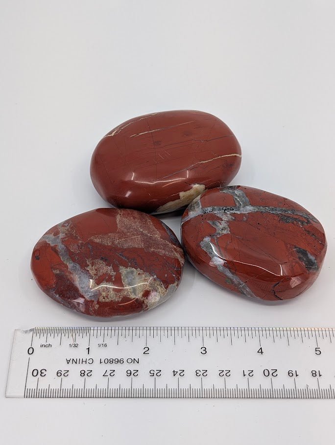 Group of Red Jasper Palm Stones (Large & XL) with ruler for size reference