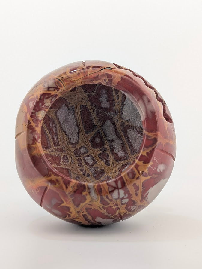 Red jasper pumpkin carving – base view showing veining