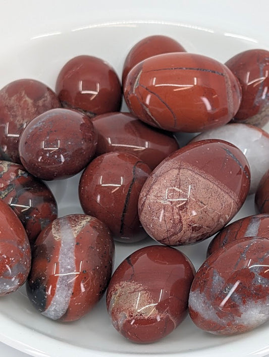 Close-up of polished Red Jasper tumbles showing color and veining