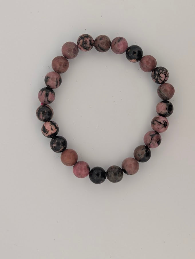 Top-down view of 8mm rhodonite round bead bracelet on white background
