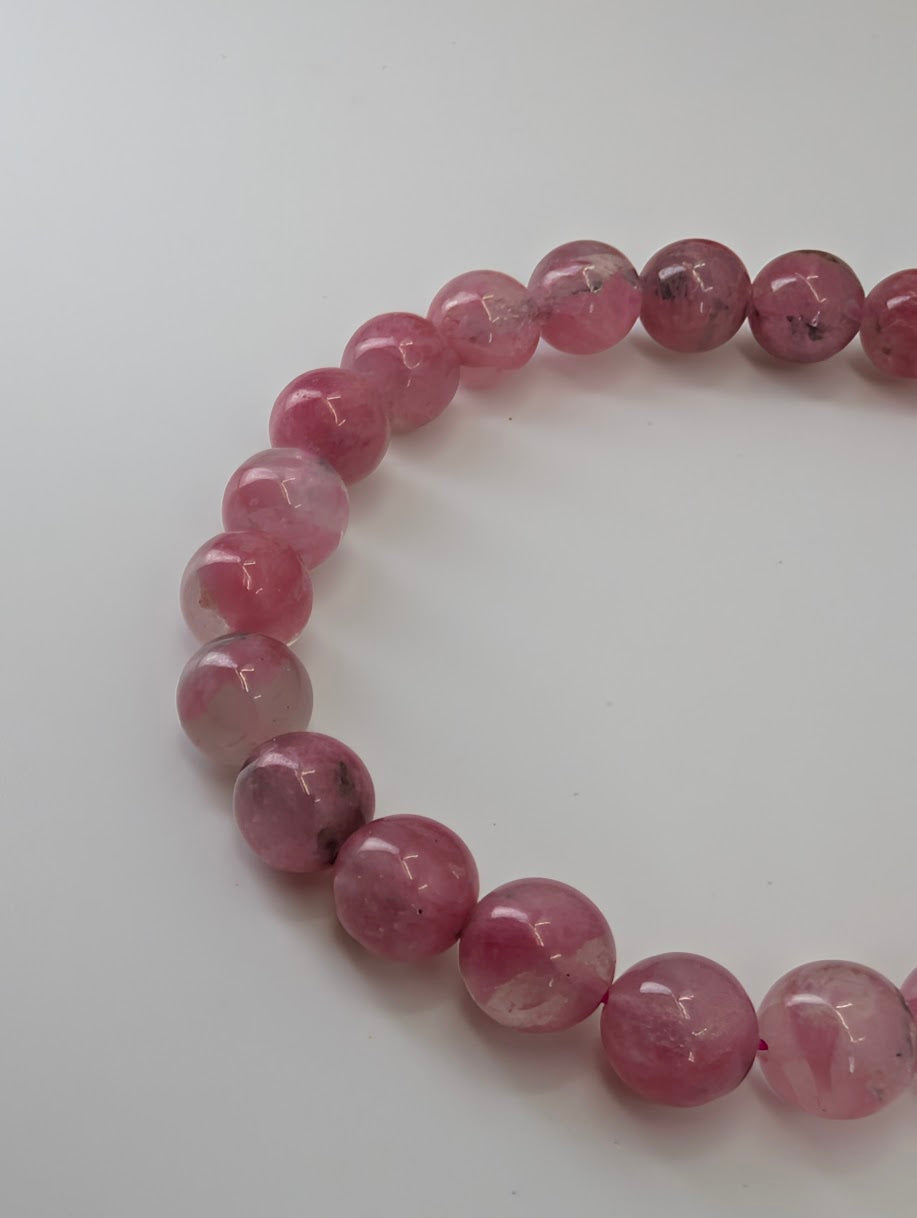 Madagascar rhodonite bracelet with 7 millimeter polished beads showing soft pink tones
