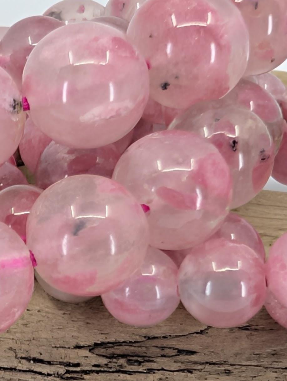 Rhodonite bracelet bead size comparison showing 7, 9, 10, and 11 millimeter variants