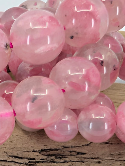 Rhodonite bracelet bead size comparison showing 7, 9, 10, and 11 millimeter variants