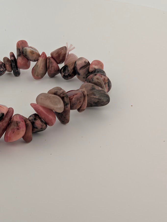 Detail of rhodonite chip bracelet with mixed pink, grey and black matrix