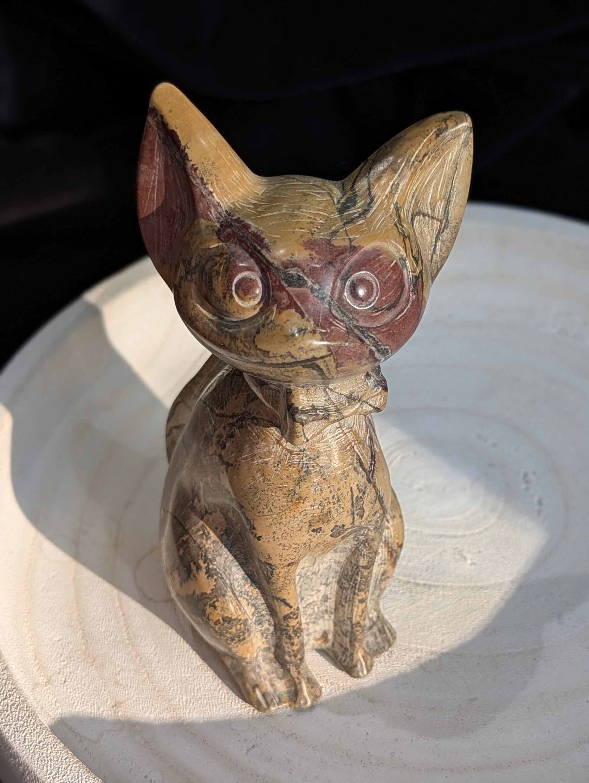 Hand-carved Picture Jasper crystal cat figurine wearing a bowtie, displaying natural tan and reddish-brown banded earthy patterns, sitting upright.