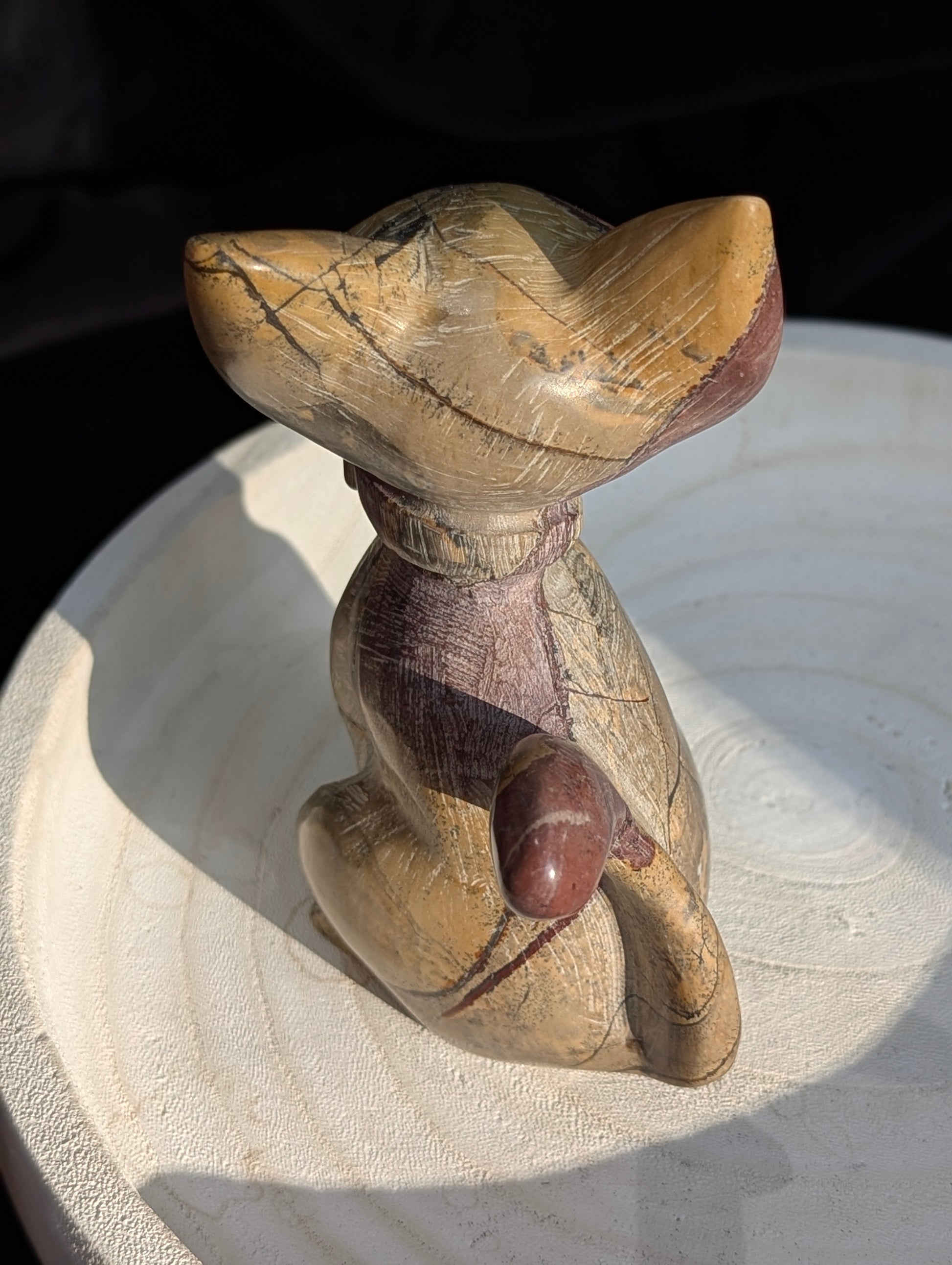 Hand-carved Picture Jasper crystal cat figurine wearing a bowtie, displaying natural tan and reddish-brown banded earthy patterns, sitting upright.