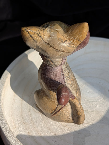Hand-carved Picture Jasper crystal cat figurine wearing a bowtie, displaying natural tan and reddish-brown banded earthy patterns, sitting upright.