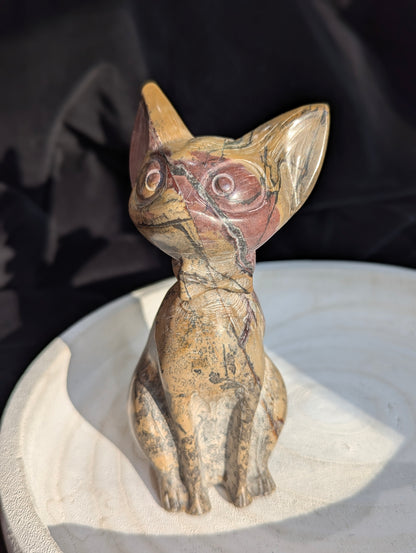 Hand-carved Picture Jasper crystal cat figurine wearing a bowtie, displaying natural tan and reddish-brown banded earthy patterns, sitting upright.