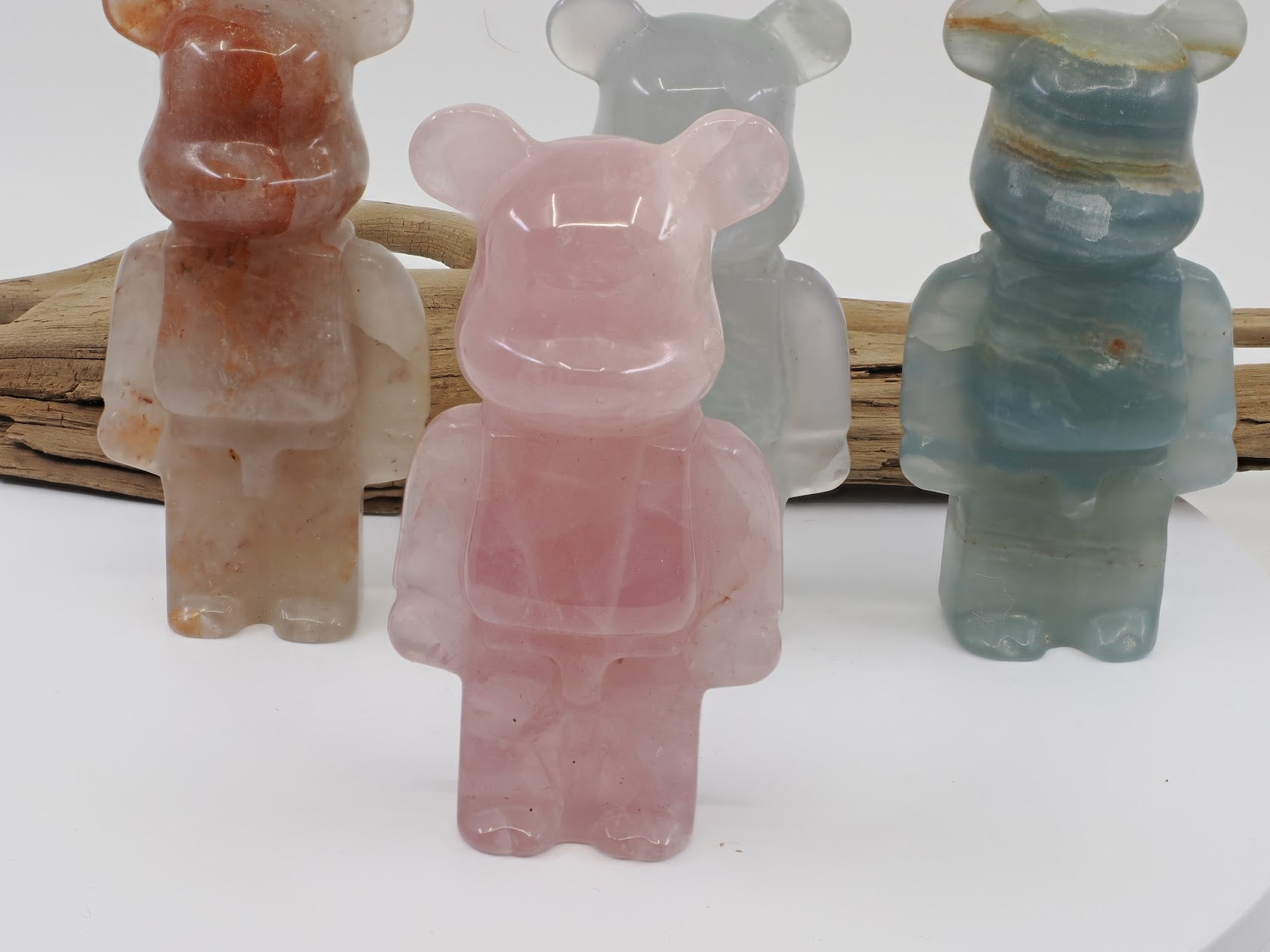 Front view of a Rose Quartz designer bear carving in a soft translucent pink with natural internal veils.