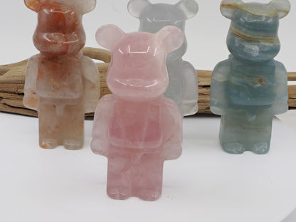 Front view of a Rose Quartz designer bear carving in a soft translucent pink with natural internal veils.