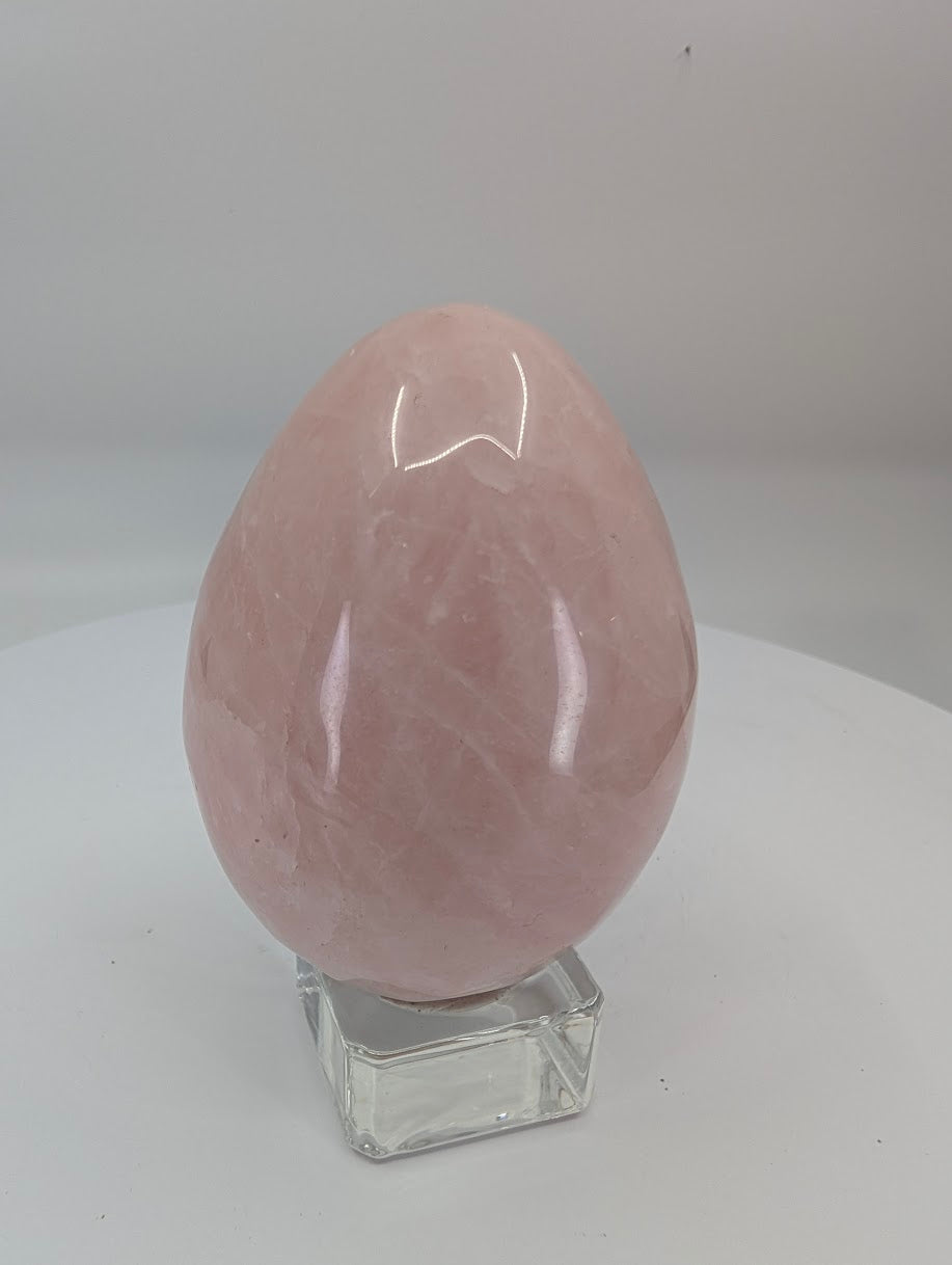 Polished rose quartz egg approximately 2.75 inches tall with soft pink color and natural translucency