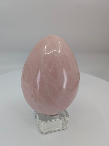 Polished rose quartz egg approximately 2.75 inches tall with soft pink color and natural translucency