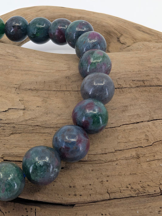 Close-up of 8mm Ruby in Kyanite beads highlighting the natural Corundum inclusions and high-gloss polish.