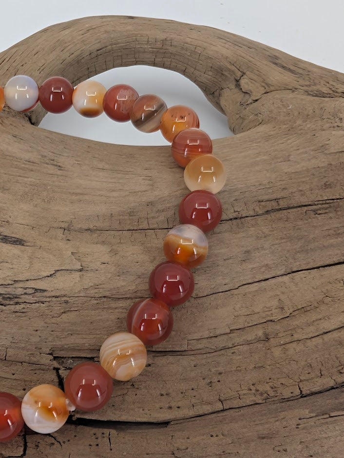 Close-up of Sardonyx beads showing layered color and polish