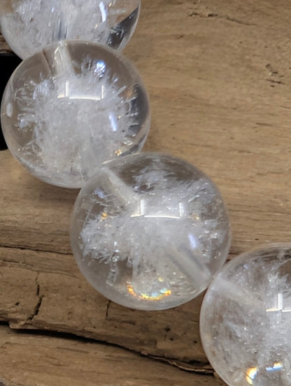Macro detail of an artisan-crafted Sea Urchin inclusion within a natural clear quartz sphere.