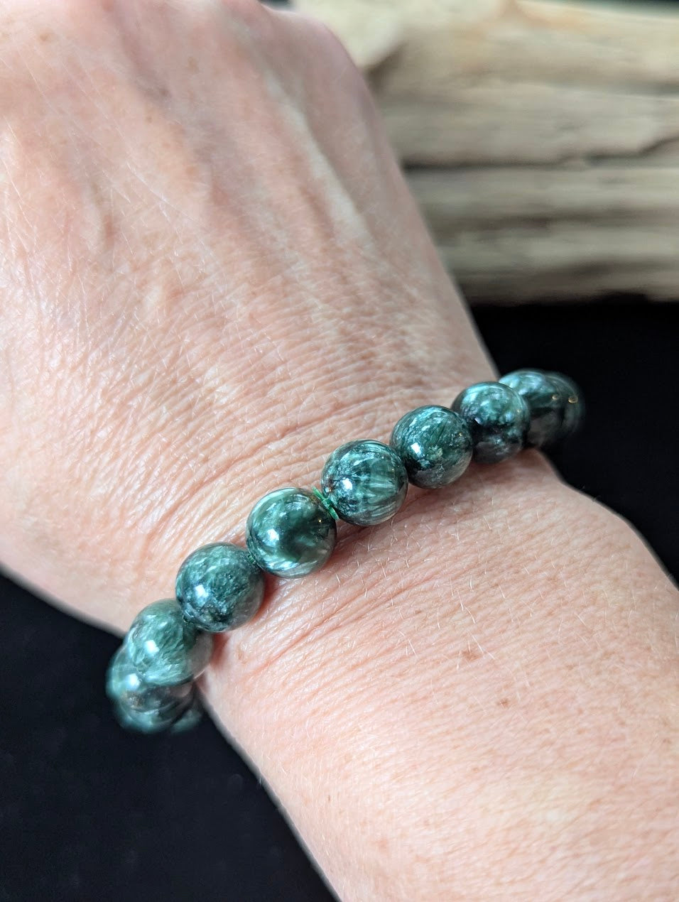 10mm Seraphinite (Clinochlore) Bracelet shown worn on a wrist.