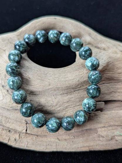 10mm Seraphinite (Clinochlore) Bracelet from Siberia, showing bold chatoyancy on driftwood.
